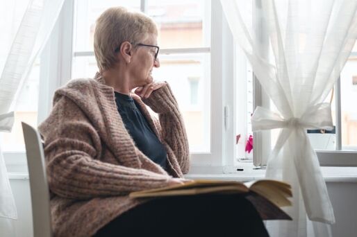 Senior woman relaxing and reflecting as a way to improve her spiritual wellness.